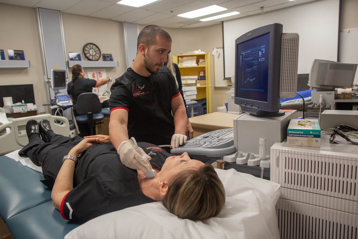 diagnostic medical sonography student using ultrasound in classroom